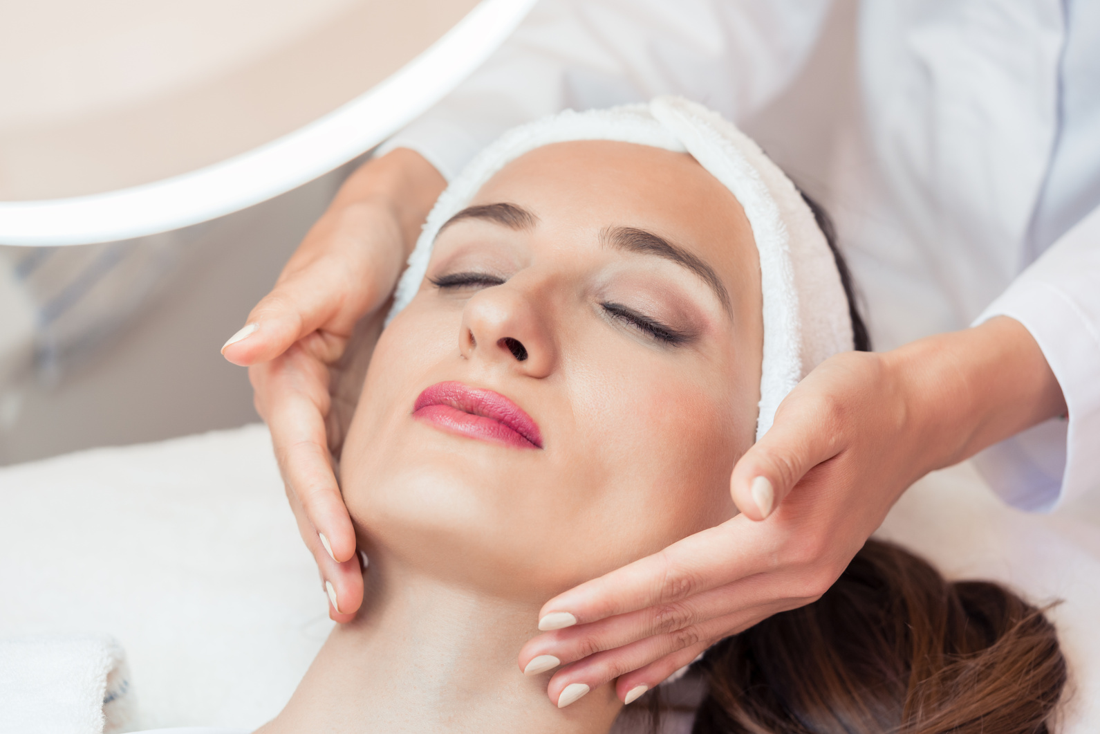 Beautiful Woman Relaxing During Facial Massage for Rejuvenation